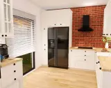 Nowoczesna ikea kuchnia projekt: białe meble, czarny lodówka, ceglana ściana i drewniany blat tworzą przytulną przestrzeń.