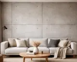 Nowoczesny salon z sofą i stolikiem kawowym. Ściana z betonu architektonicznego, idealna do wykończenia specjalnymi farbami.