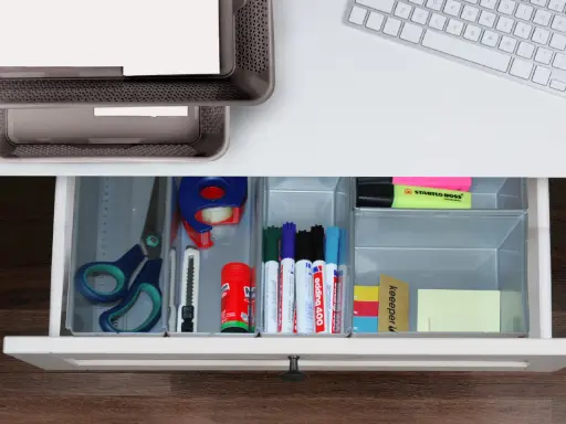 Inspiracje na organizację biurka: nożyczki, taśma, markery, linijka i karteczki w szufladzie.